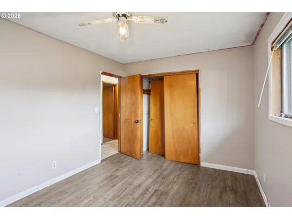 a view of an empty room with wooden floor