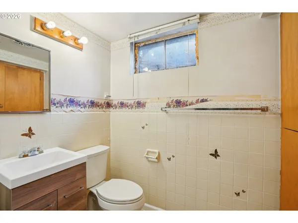 a bathroom with a sink mirror vanity and toilet