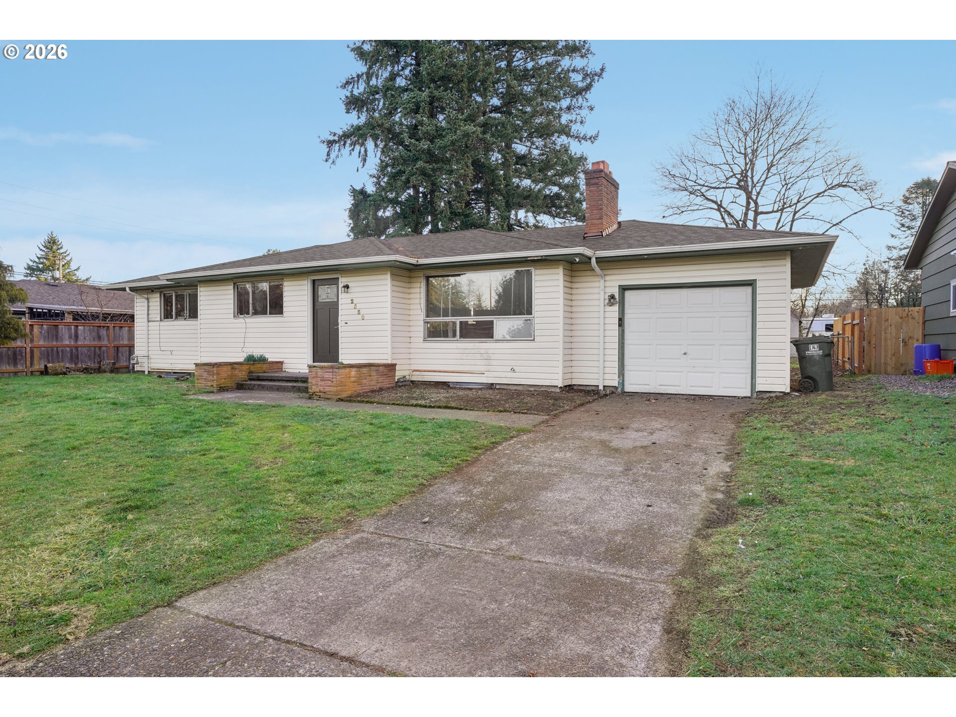 2530 Southeast 190th Avenue Gresham, OR 97030 - Photo 3 of 35 a view of a yard in front of a house with plants and large tree