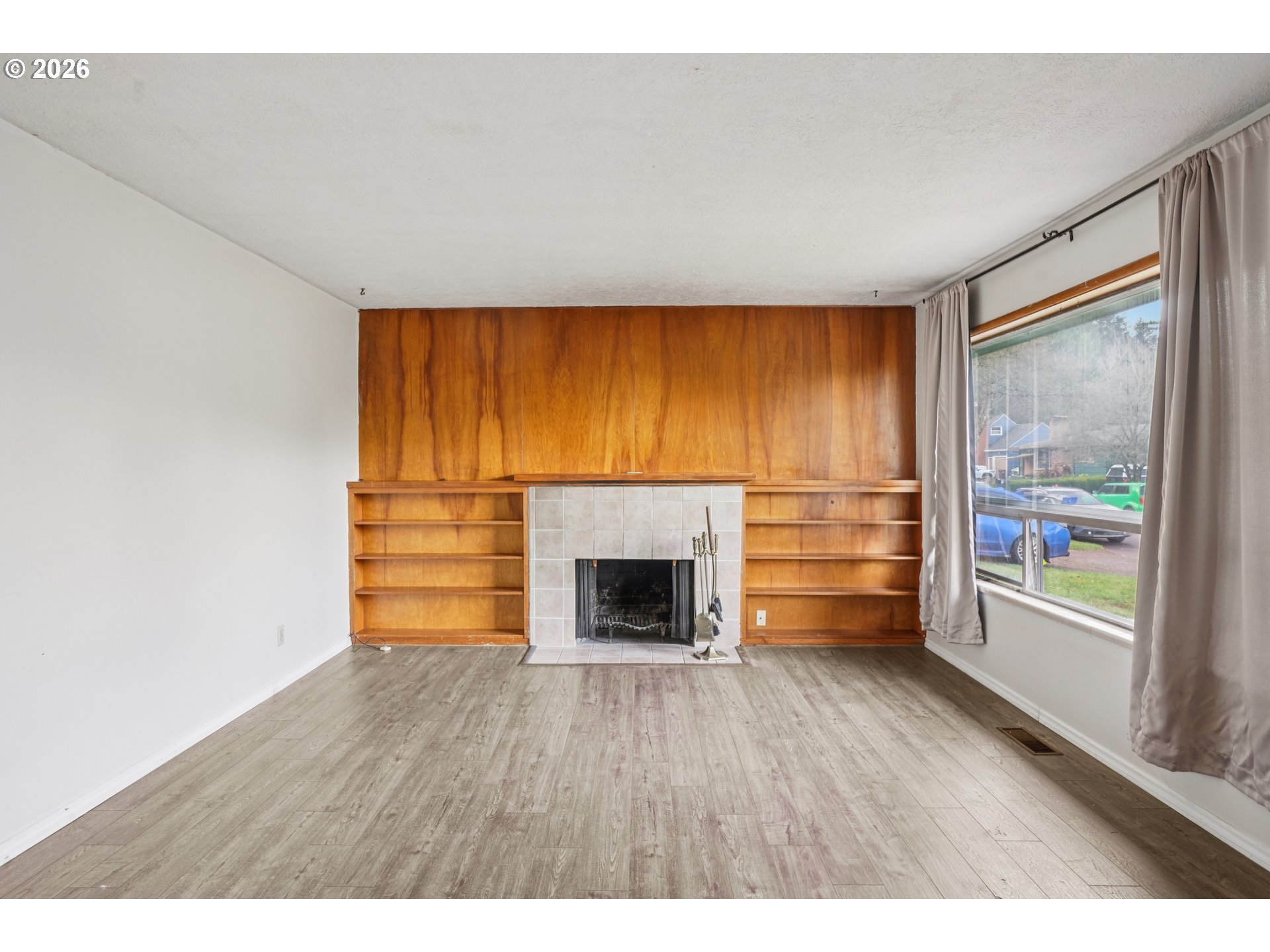 2530 Southeast 190th Avenue Gresham, OR 97030 - Photo 6 of 35 a living room with a fireplace and wooden floor