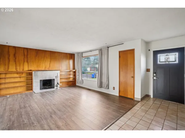 a view of empty room with a fireplace