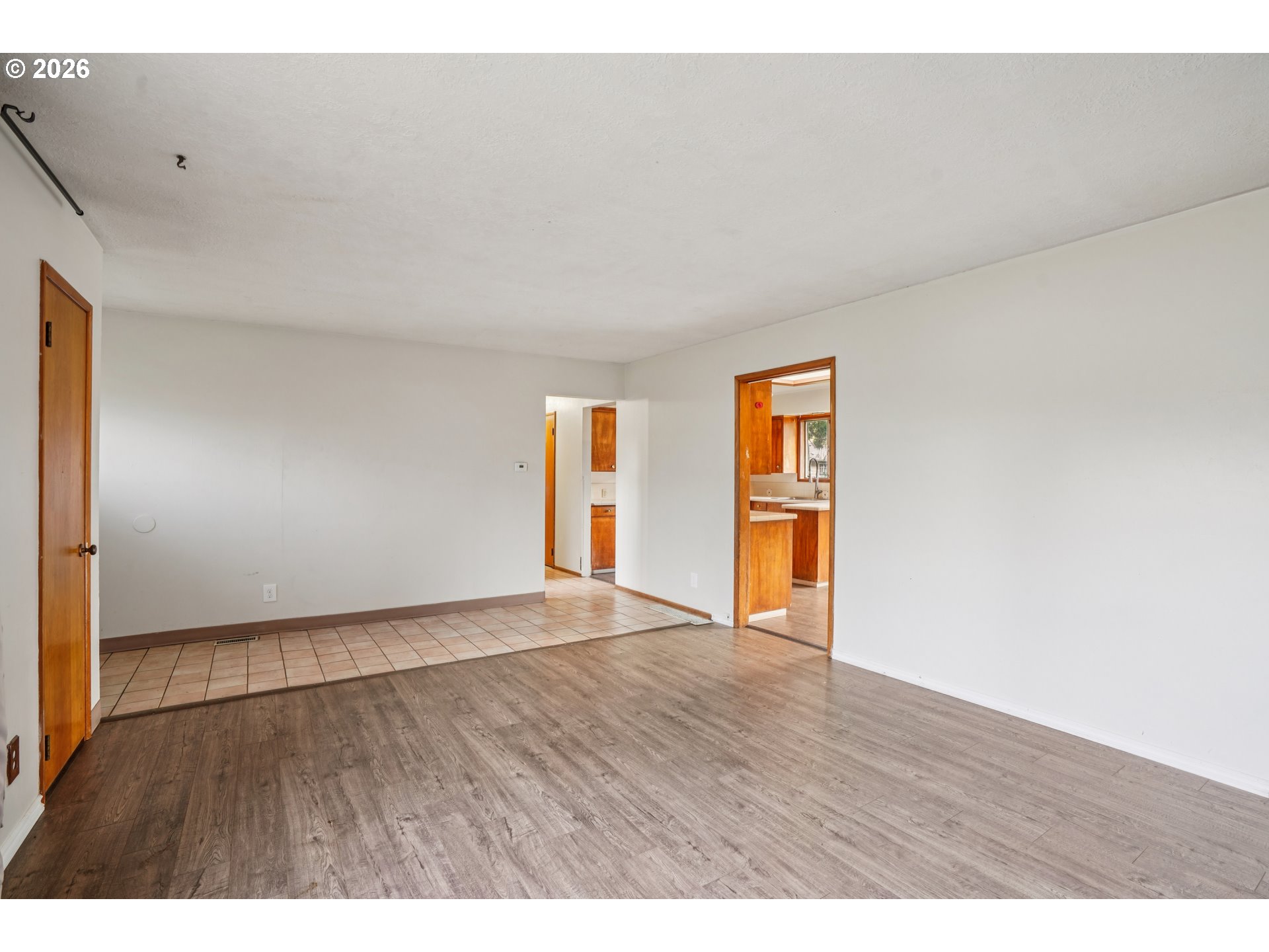 2530 Southeast 190th Avenue Gresham, OR 97030 - Photo 8 of 35 a view of an empty room with wooden floor and windows