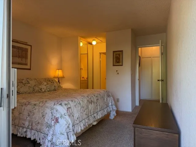 a bedroom with a bed and a walk in closet