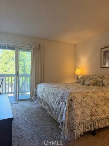 a bedroom with a large bed and a large window