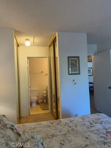 a large bed sitting in a bedroom next to a lamp