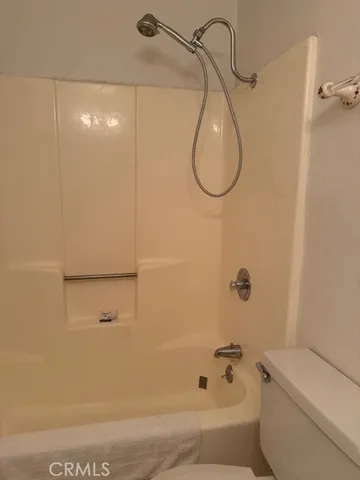 a bathroom with a shower and a toilet