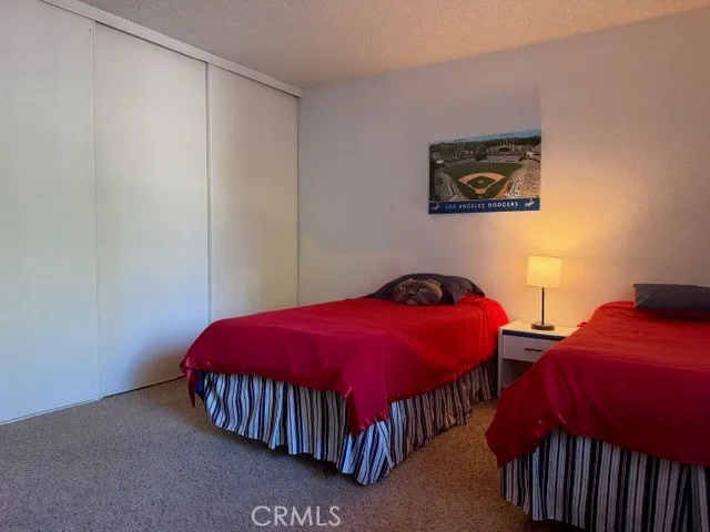 a bedroom with two beds and a lamp