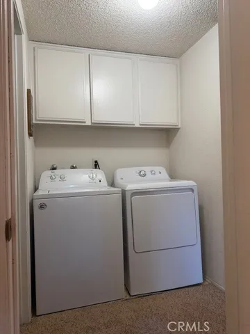 a bedroom with two beds and a lamp