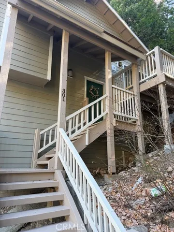 a view of a house with backyard and deck