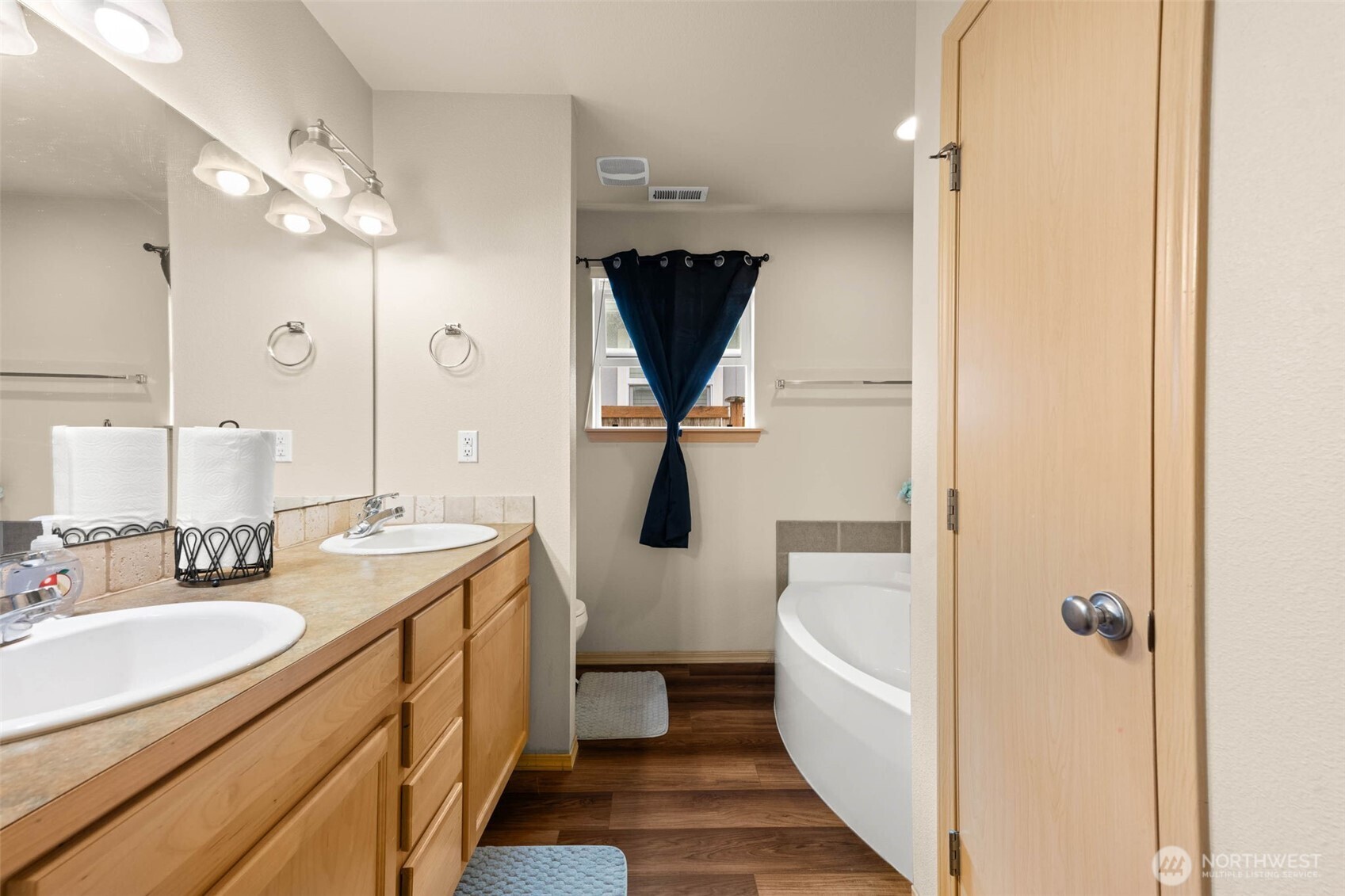 20009 96th Avenue East Graham, WA 98338 - Photo 18 of 40 a bathroom with a double vanity sink a toilet and shower