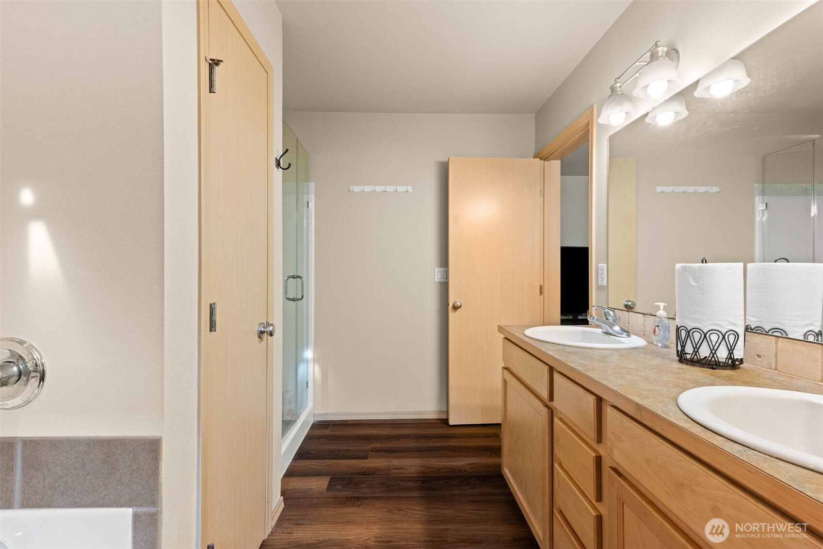 20009 96th Avenue East Graham, WA 98338 - Photo 19 of 40 a bathroom with a sink a mirror and a shower