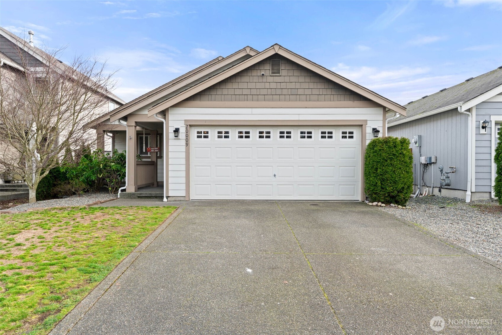 20009 96th Avenue East Graham, WA 98338 - Photo 2 of 40 a front view of a house with a yard and garage