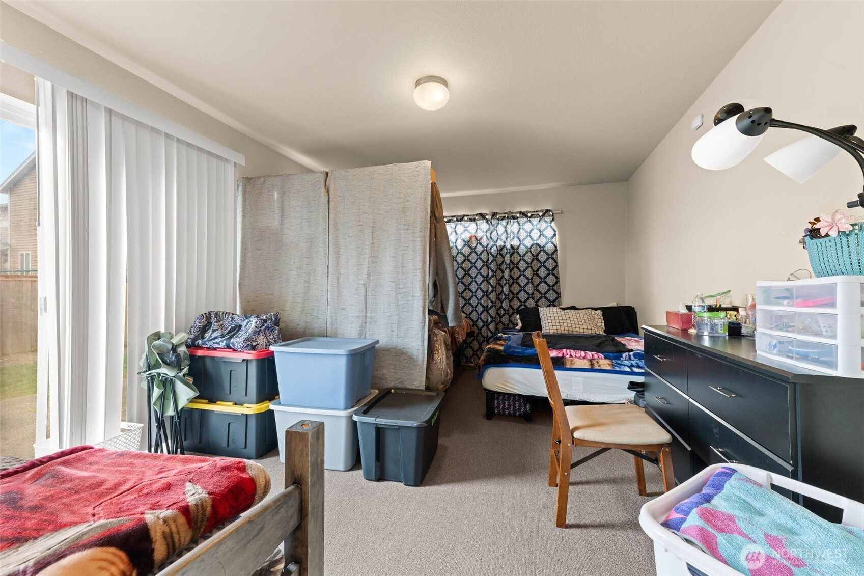 20009 96th Avenue East Graham, WA 98338 - Photo 26 of 40 a bedroom with a bed and a potted plant