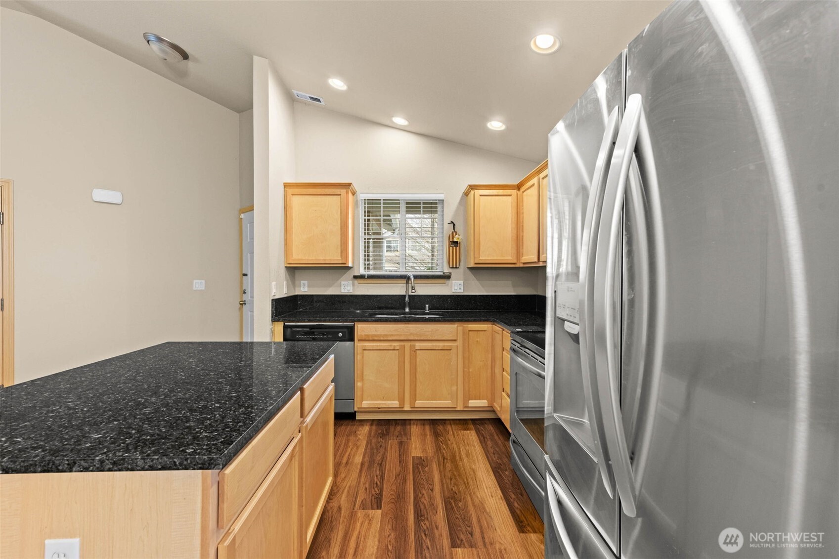 20009 96th Avenue East Graham, WA 98338 - Photo 8 of 40 a kitchen with kitchen island a counter top space a sink stainless steel appliances and cabinets
