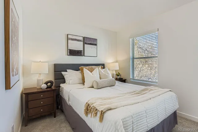 a bedroom with a bed and a night stand