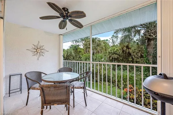 a balcony with table and chairs