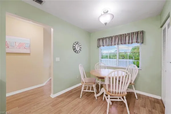 a view of a dining room with furniture wooden floor and a chandelier