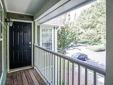 a view of a balcony with wooden floor