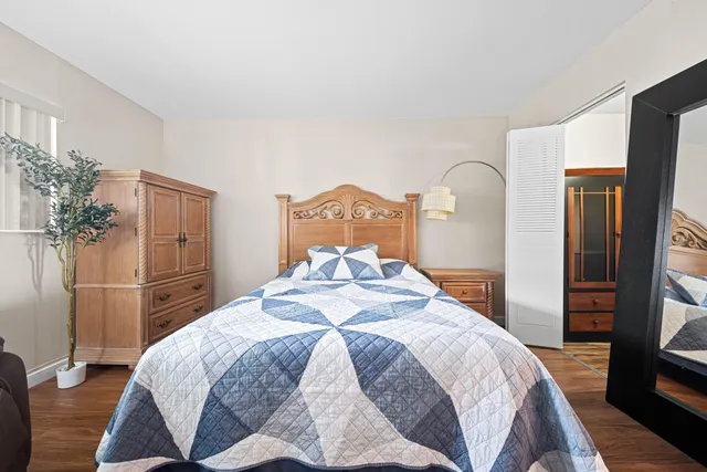 a bedroom with a bed and a television