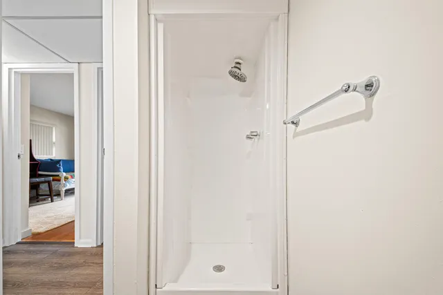 a bathroom with a glass shower door