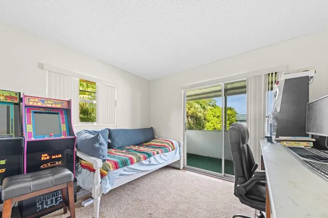 a bedroom with furniture and a flat screen tv