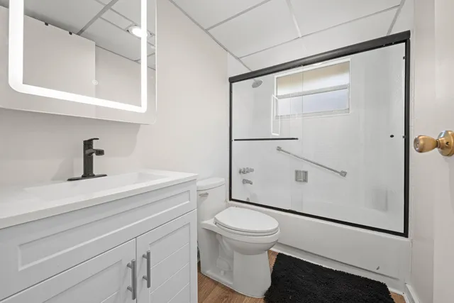 a bathroom with a toilet a sink and a shower
