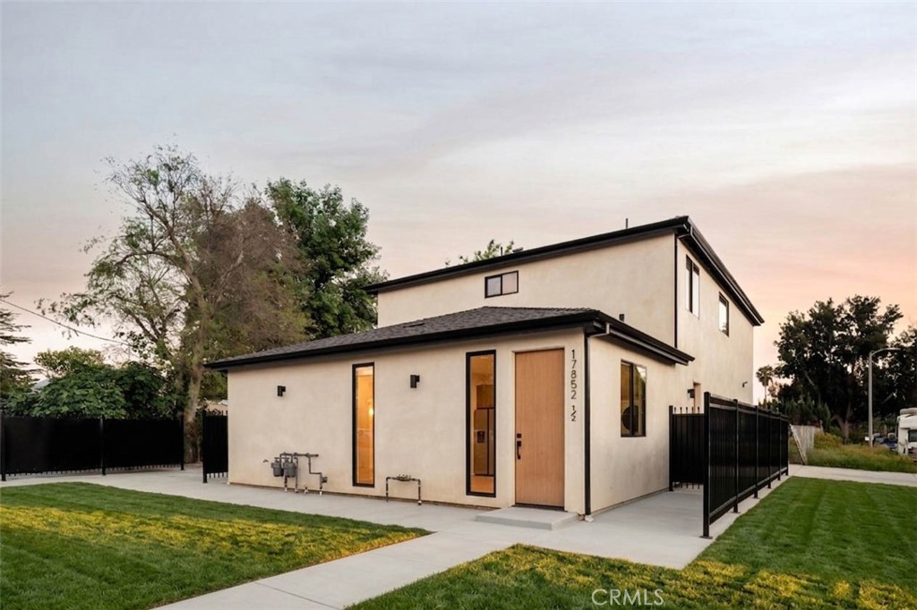 17852 Saticoy Street Reseda, CA 91335 - Photo 1 of 28 a front view of a house with yard and garage