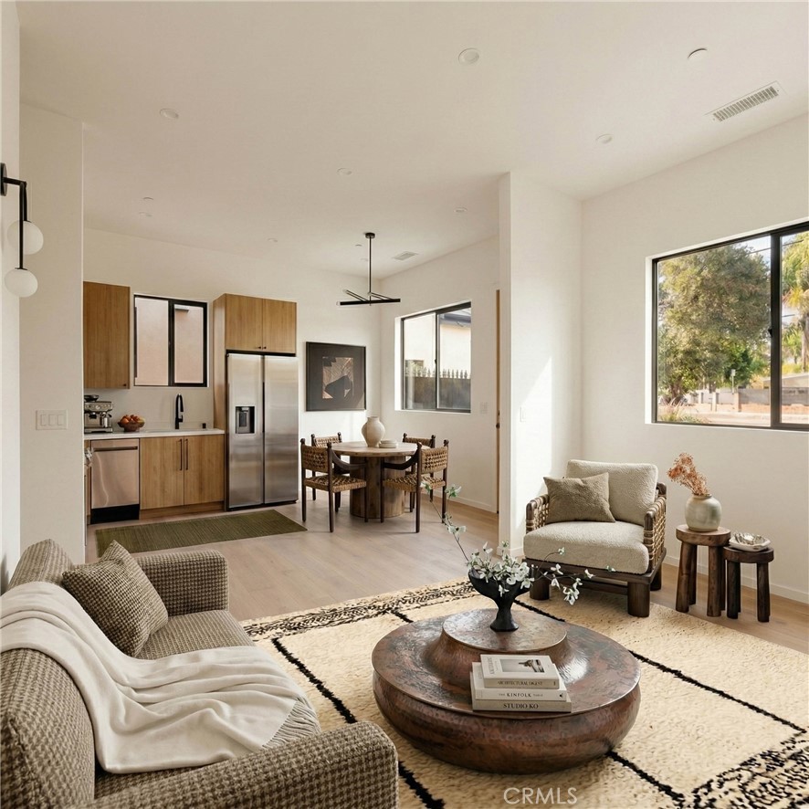 17852 Saticoy Street Reseda, CA 91335 - Photo 18 of 28 a living room with furniture and a chandelier
