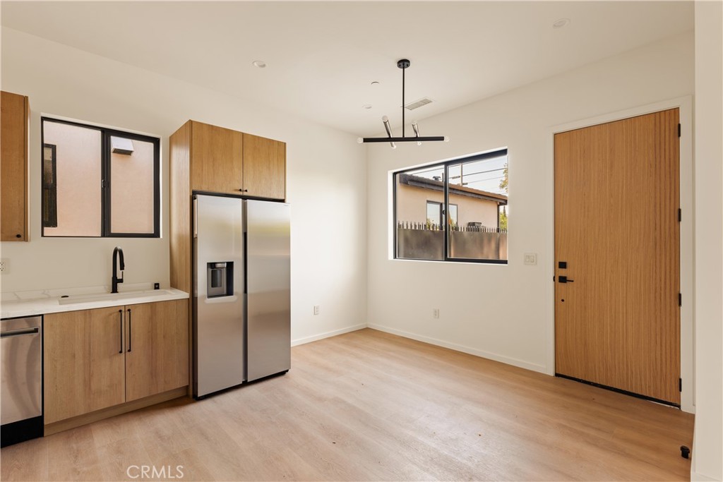 17852 Saticoy Street Reseda, CA 91335 - Photo 19 of 28 a view of an empty room with window and wooden floor