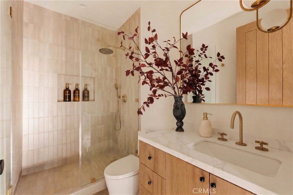 17852 Saticoy Street Reseda, CA 91335 - Photo 22 of 28 a bathroom with a sink a toilet and shower