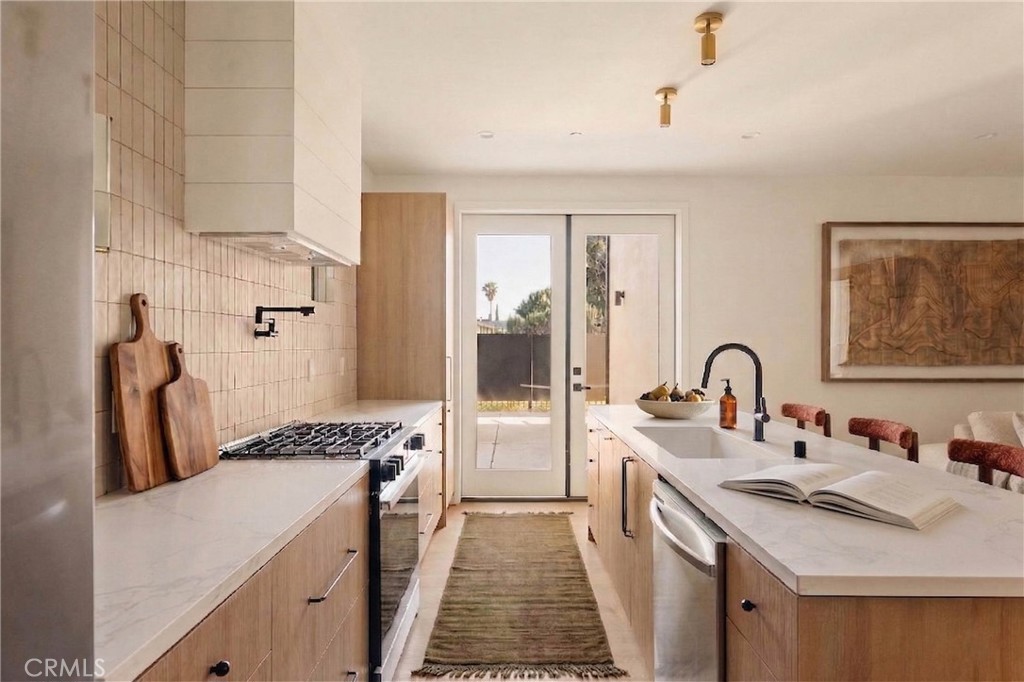 17852 Saticoy Street Reseda, CA 91335 - Photo 6 of 28 a kitchen with sink refrigerator and stove