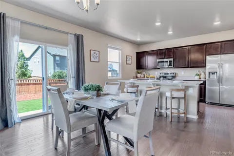 a view of a dining room with furniture window and wooden floor