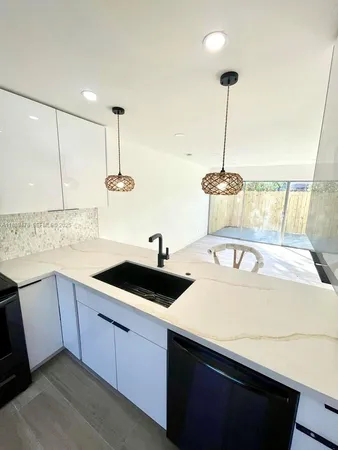 a kitchen with a sink and cabinets