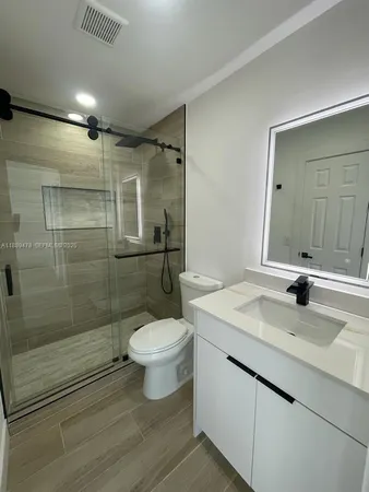 a bathroom with a sink toilet and shower