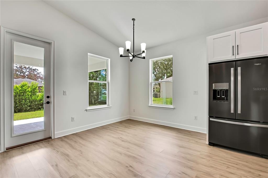 6589 Freeport Drive Spring Hill, FL 34608 - Photo 15 of 57 a view of a kitchen with wooden floor electronic appliances and windows
