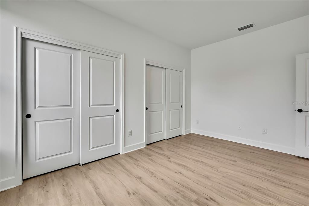 6589 Freeport Drive Spring Hill, FL 34608 - Photo 26 of 57 a view of an empty room with wooden floor