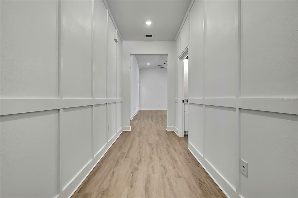 6589 Freeport Drive Spring Hill, FL 34608 - Photo 3 of 57 a view of a hallway with wooden floor and staircase