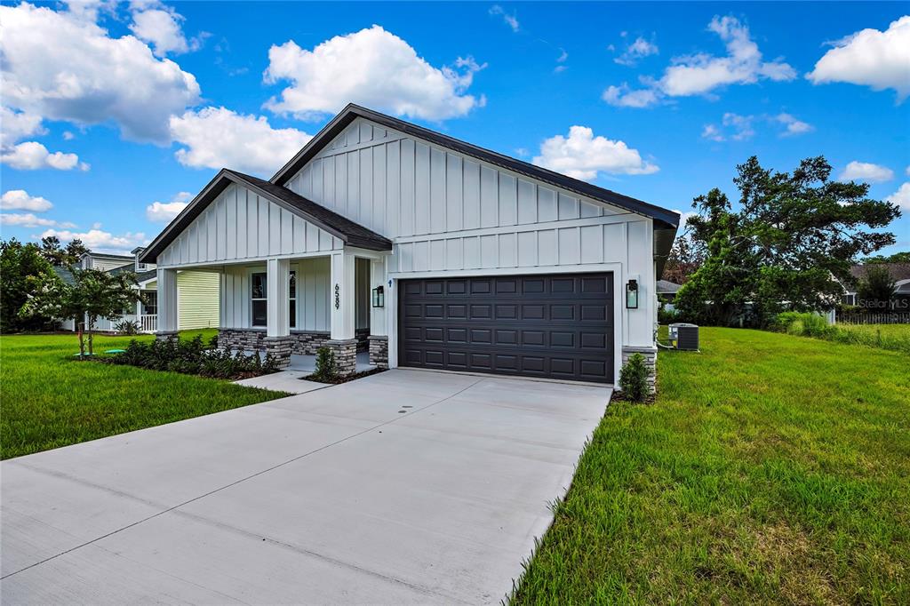 6589 Freeport Drive Spring Hill, FL 34608 - Photo 43 of 57 a front view of house with yard and green space