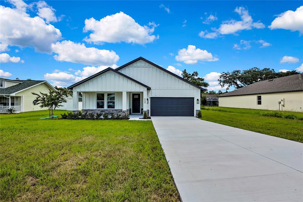 6589 Freeport Drive Spring Hill, FL 34608 - Photo 49 of 57 a front view of house with yard and green space
