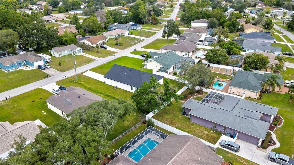 6589 Freeport Drive Spring Hill, FL 34608 - Photo 52 of 57 an aerial view of a house with a swimming pool yard and outdoor seating