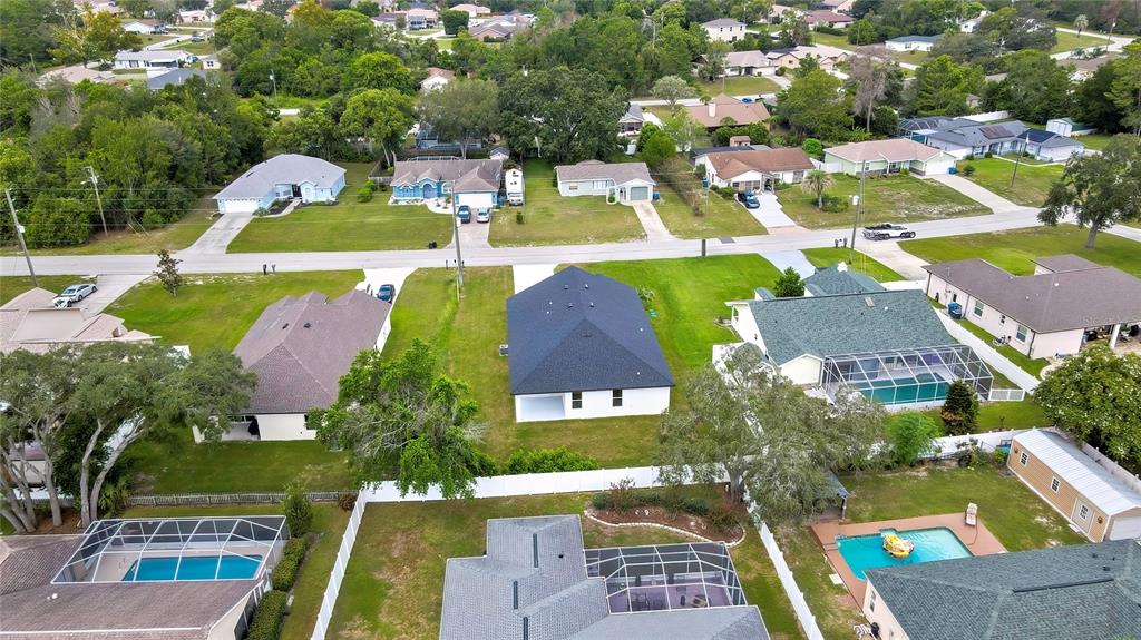 6589 Freeport Drive Spring Hill, FL 34608 - Photo 53 of 57 an aerial view of residential houses with outdoor space and swimming pool