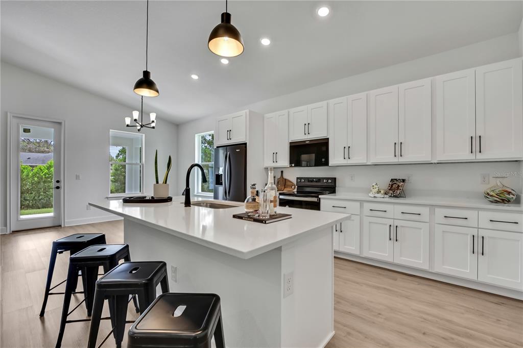 6589 Freeport Drive Spring Hill, FL 34608 - Photo 9 of 57 a kitchen with cabinets a sink and appliances
