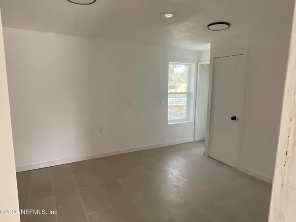 a view of a hallway with wooden shelves