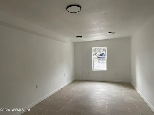 a view of a kitchen with a sink and windows