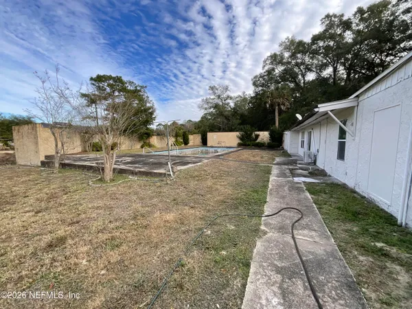 a front view of house with yard and trees