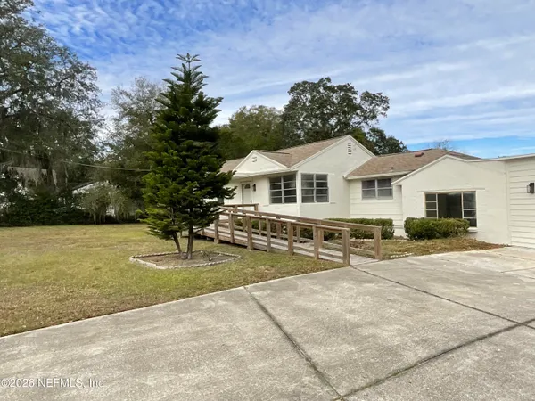 a view of a house with a yard