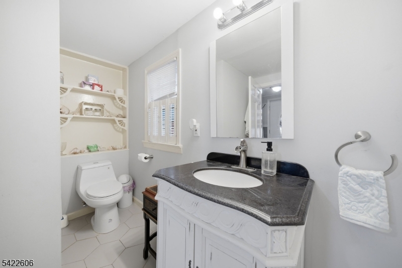 399 Springbrook Trail Sparta, NJ 07871 - Photo 16 of 27 a bathroom with a granite countertop sink and a mirror