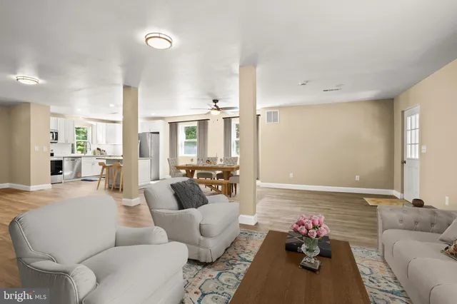 a living room with furniture and flowers