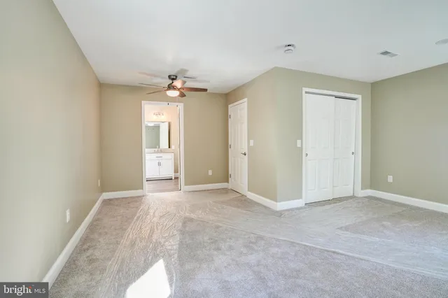 a bathroom with a double vanity sink a mirror and next to a window