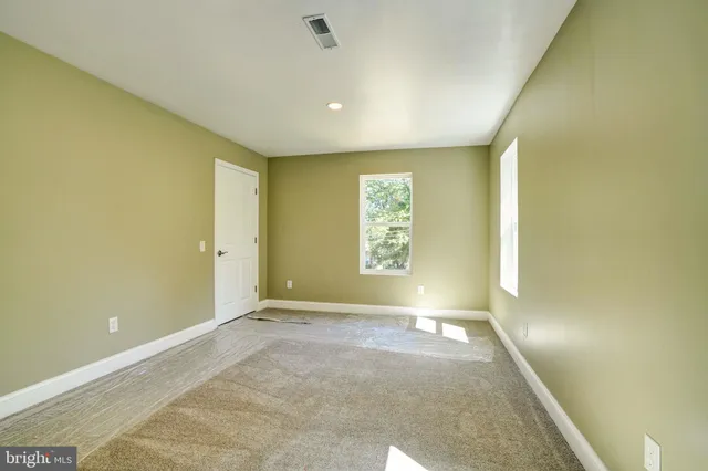 a bathroom with a granite countertop sink a mirror and a bathtub